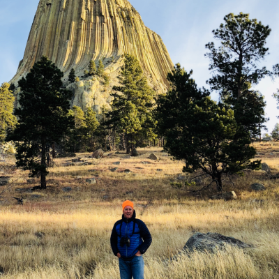 Man standing in front of Devils Tower, South Dakota