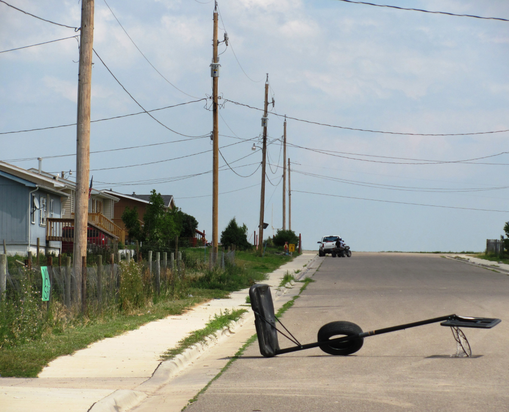 Street with basketball hoop laying down in the middle